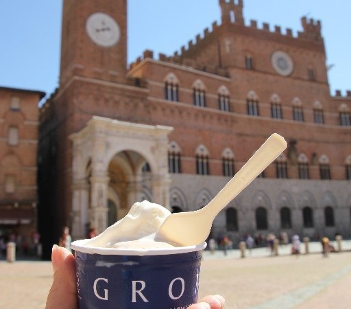 Eating gelato while sitting on the brick ground of Piazza del Campo